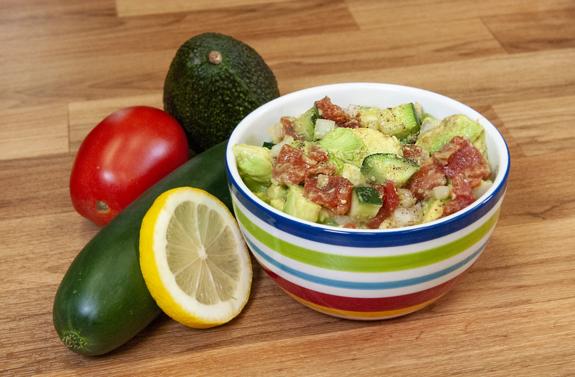 A fresh salad with avocado, tomato and cucumber
